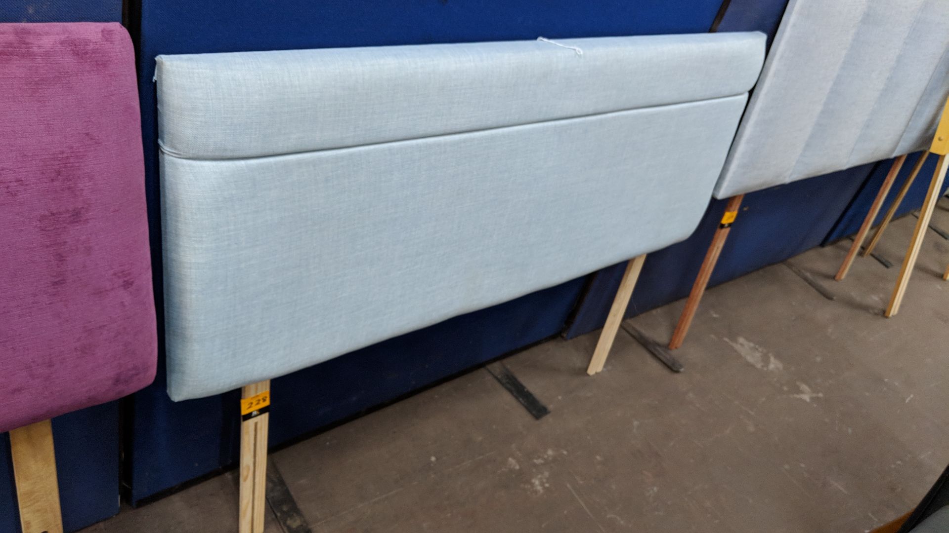 Pale blue upholstered headboard approximately 54" wide IMPORTANT: Please remember goods successfully