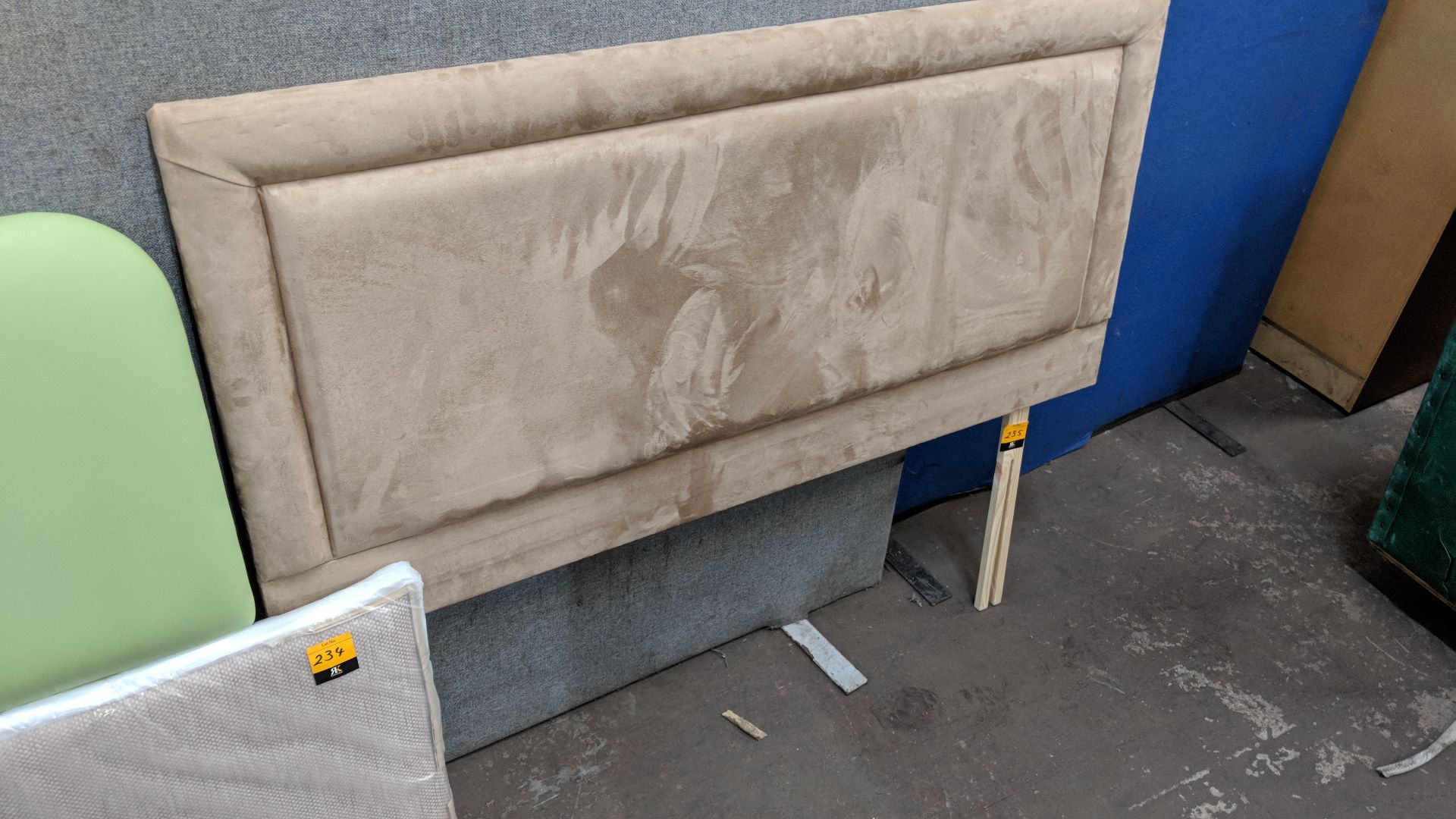 Light brown upholstered headboard in suede type fabric approximately 54" wide IMPORTANT: Please