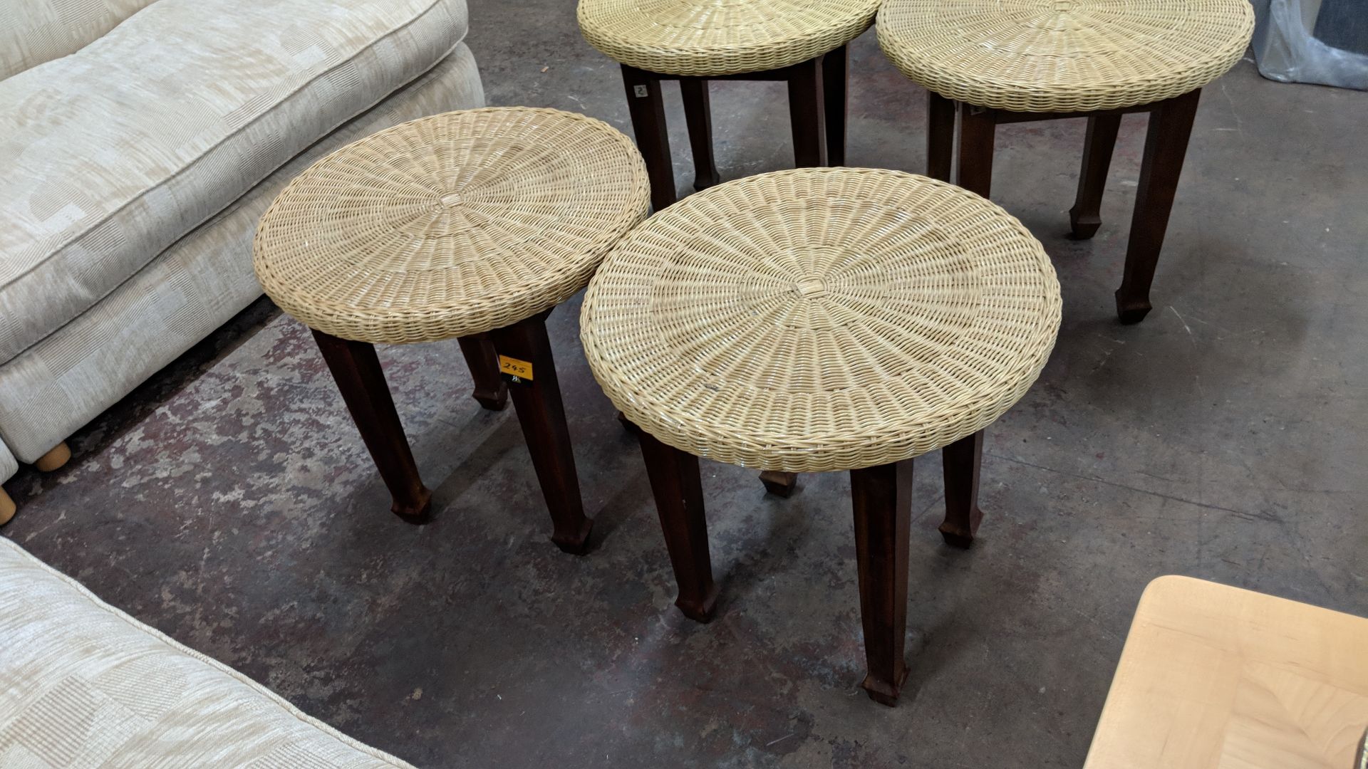 Pair of round tables with wooden legs & wicker type top, each table having a diameter of