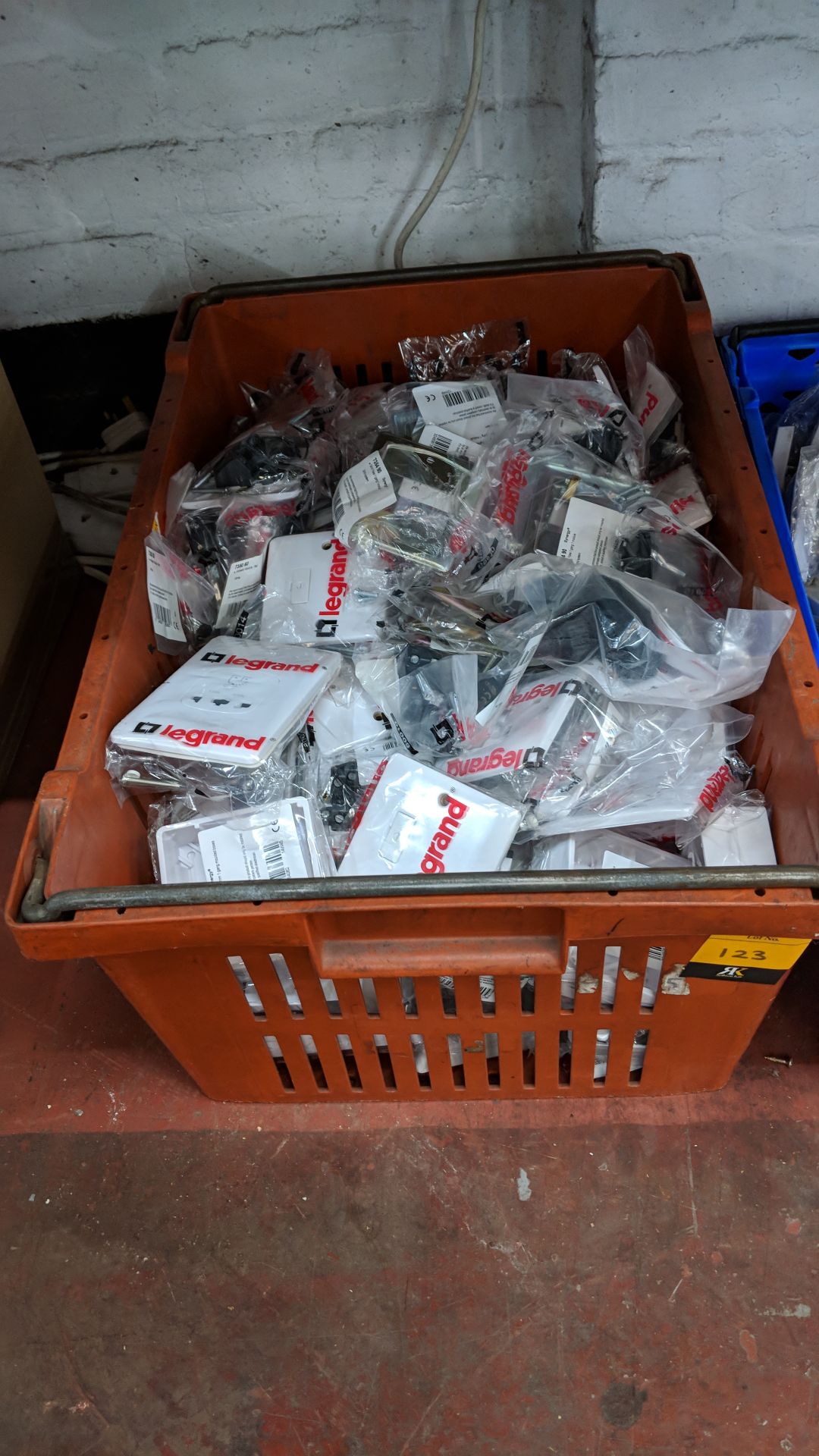 Contents of a crate consisting of a large quantity of Legrand sockets, switches and similar -