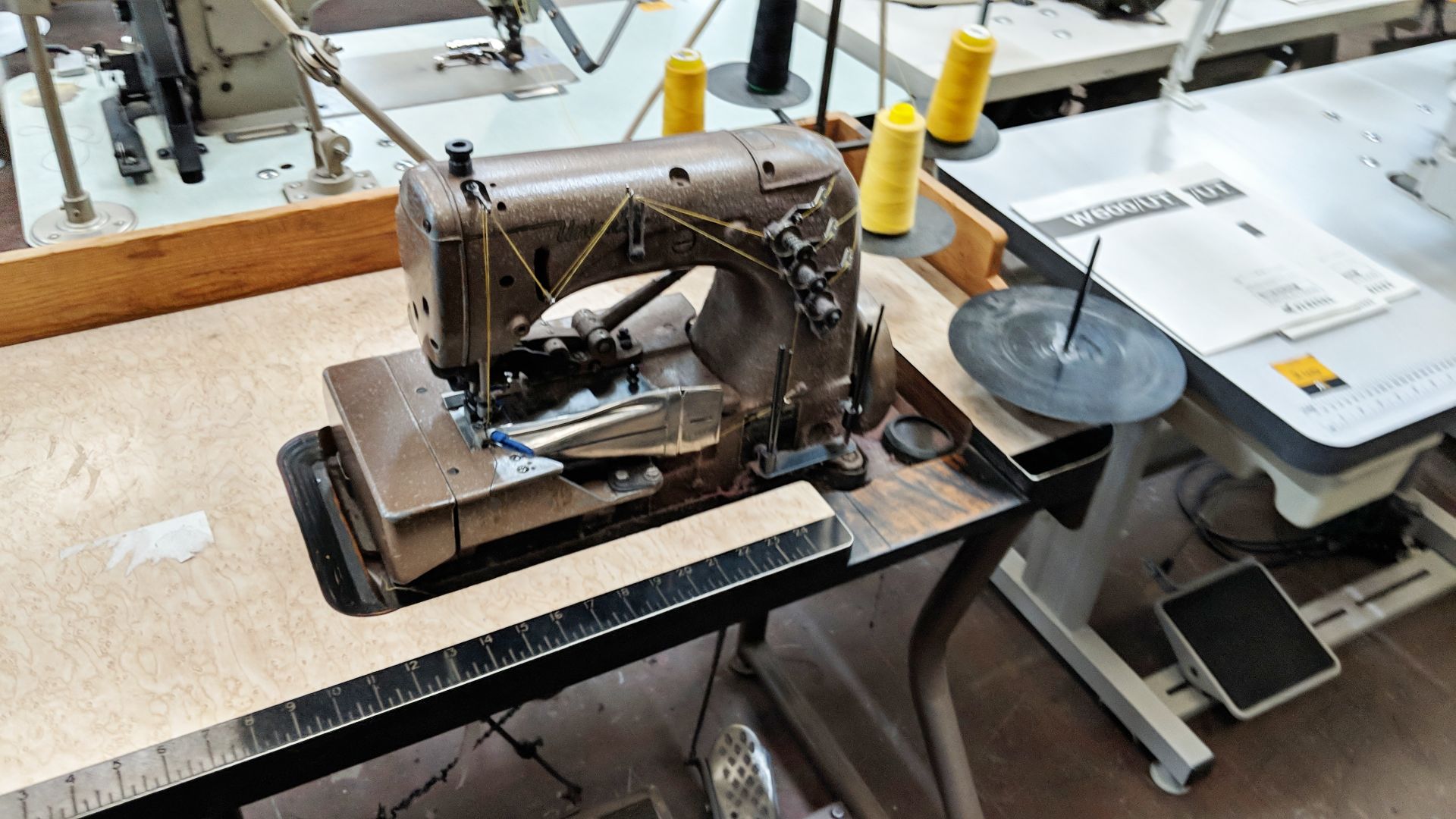 Union Special overlocker sewing machine on bench with tape feed attachments, including foot & hand - Image 3 of 8
