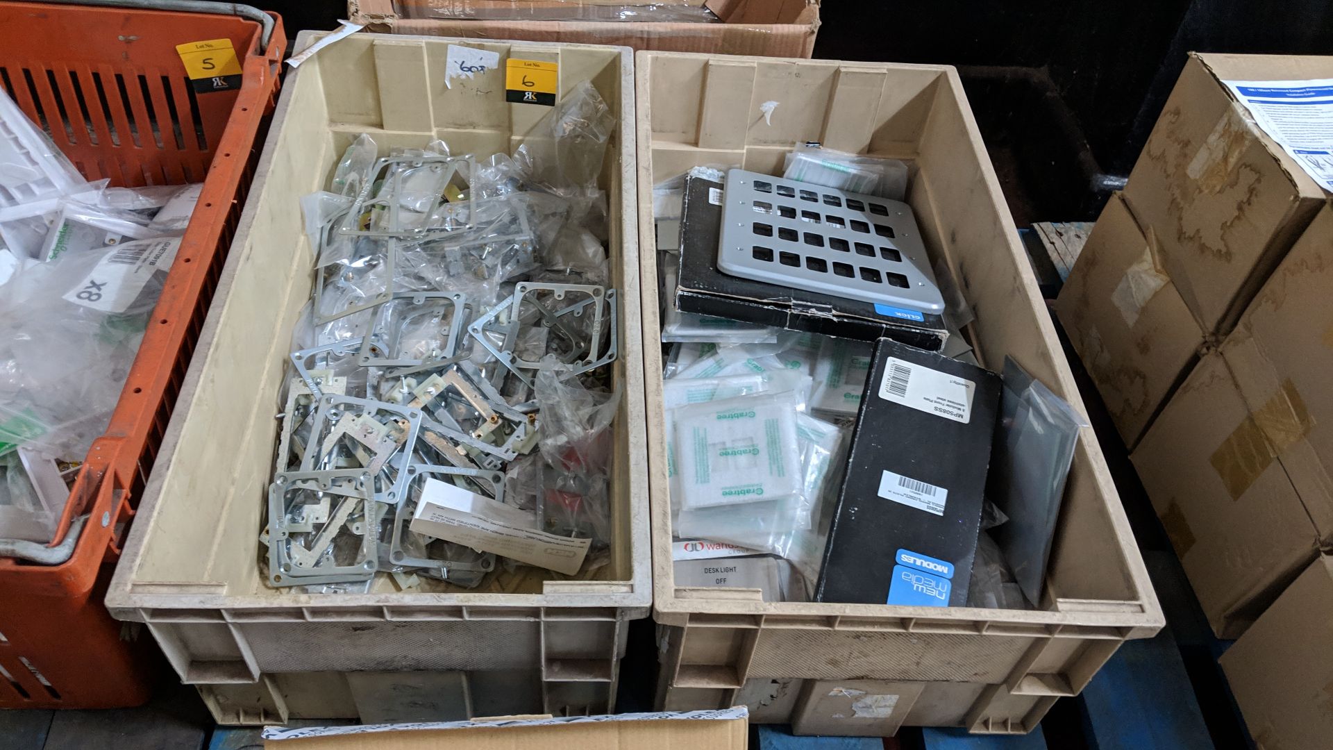 The contents of 2 crates of assorted metal plates, brackets & similar This lot is one of a number of