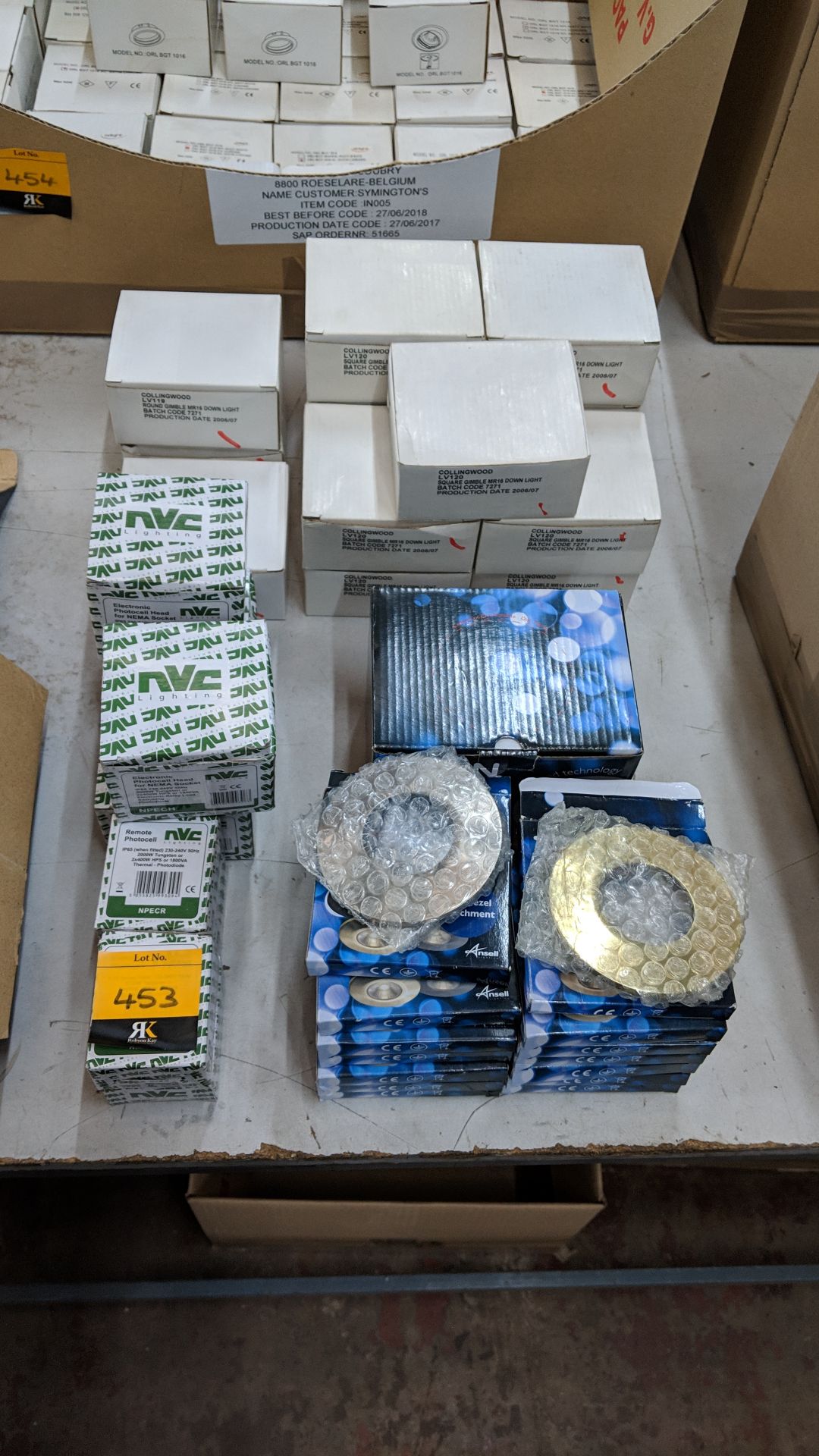 Quantity of assorted downlight gimbals, surrounds & photo cells This lot is one of a number of