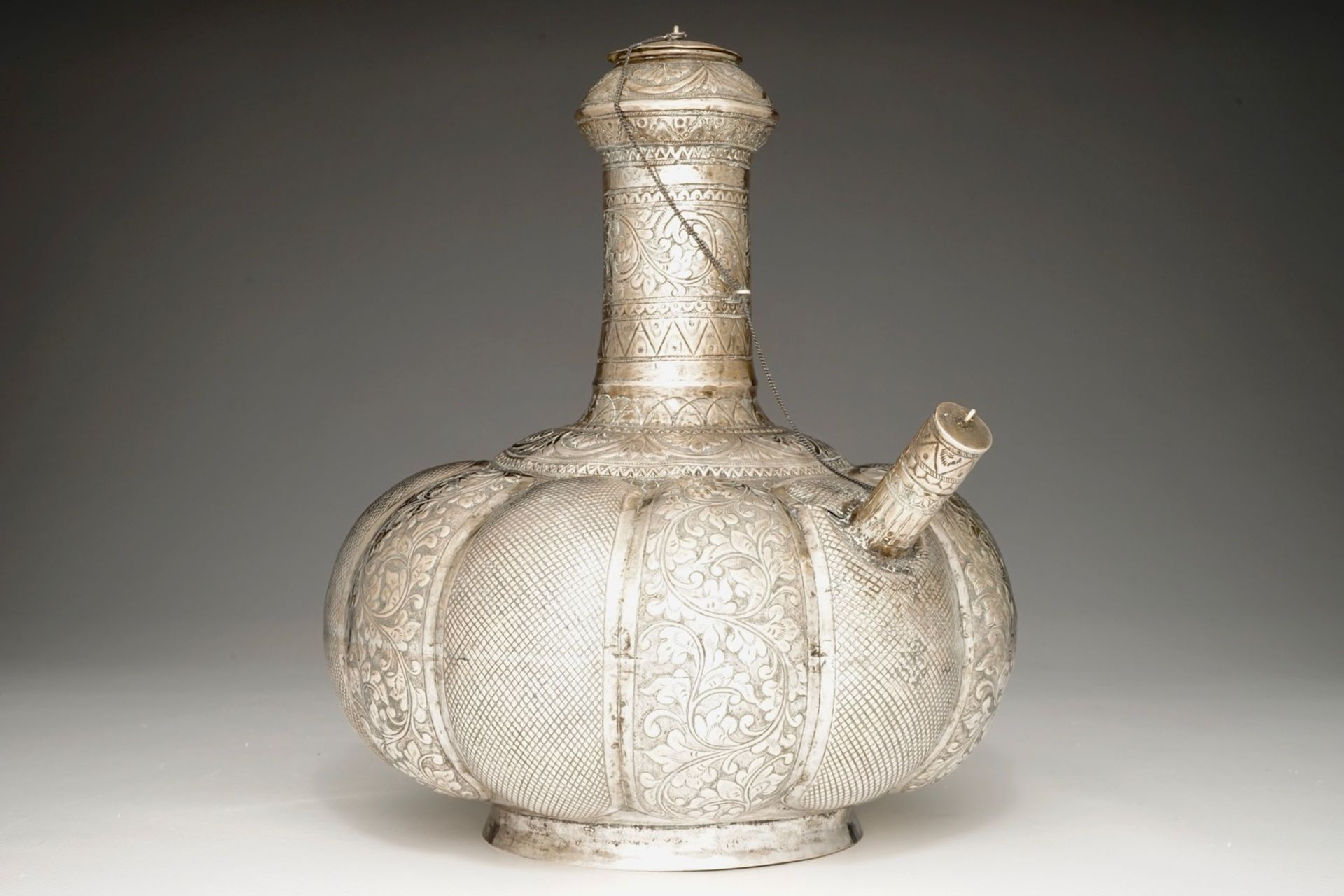 A silvered brass kendi, Mughal, India, 18/19th C. H.: 27 cm - L.: 24 cm We have more lots