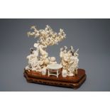 A Chinese carved ivory group on inlaid wooden base, 1st half 20th C.