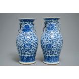 A pair of Chinese blue and white flower scroll vases, 19th C.