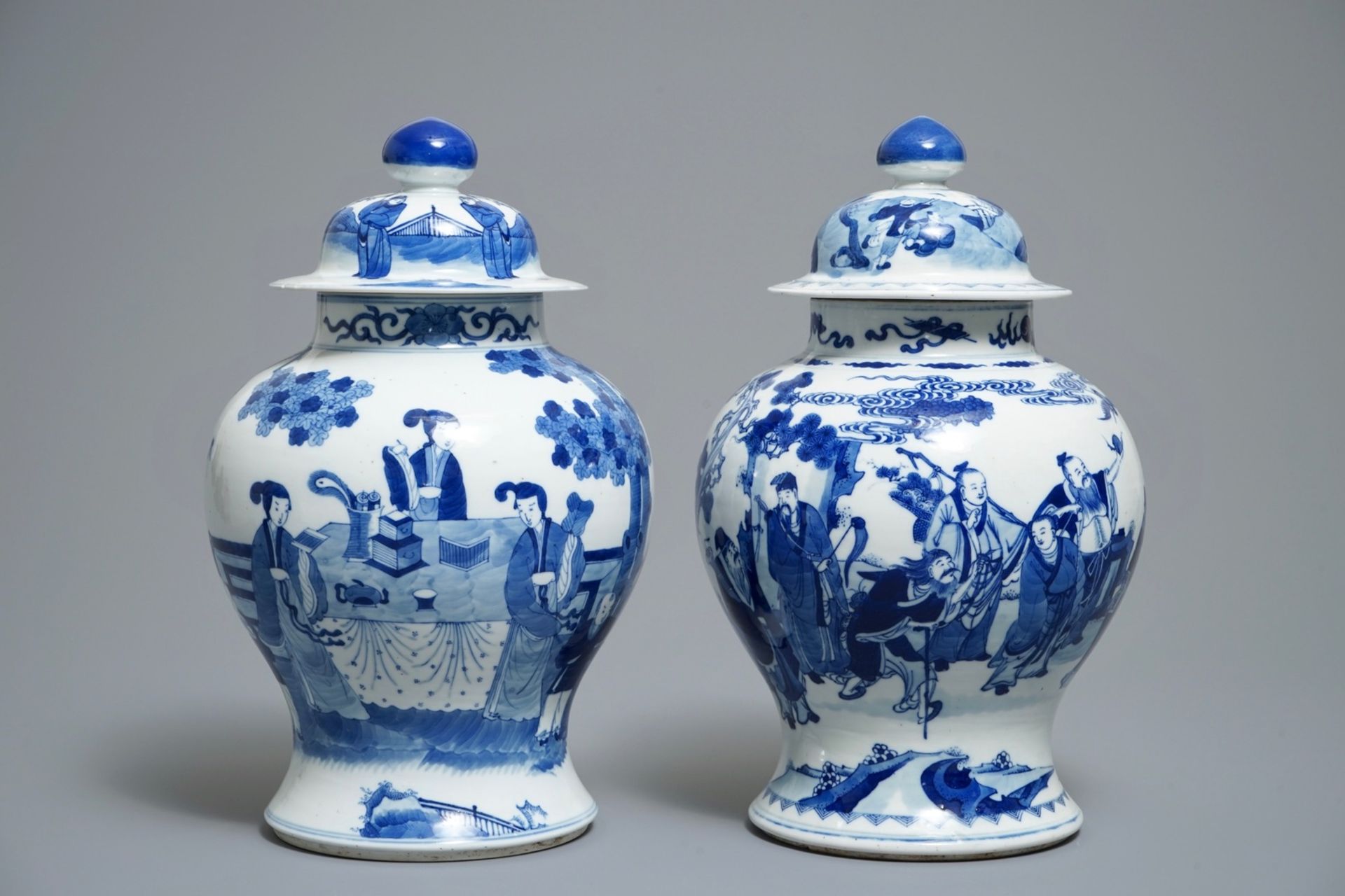 Two Chinese blue and white vases and covers with figures, 19th C.