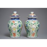 A pair of Chinese wucai vases and covers, Chenghua mark, 19/20th C.