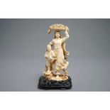 A Chinese carved ivory group of a lady and her son, 1st half 20th C.
