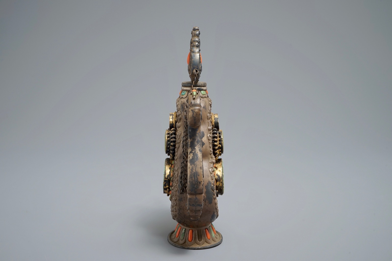 A silverd and parcel-gilt brass jug inlaid with turquoise and coral, Tibet or Mongolia, 19th C. - Image 5 of 7