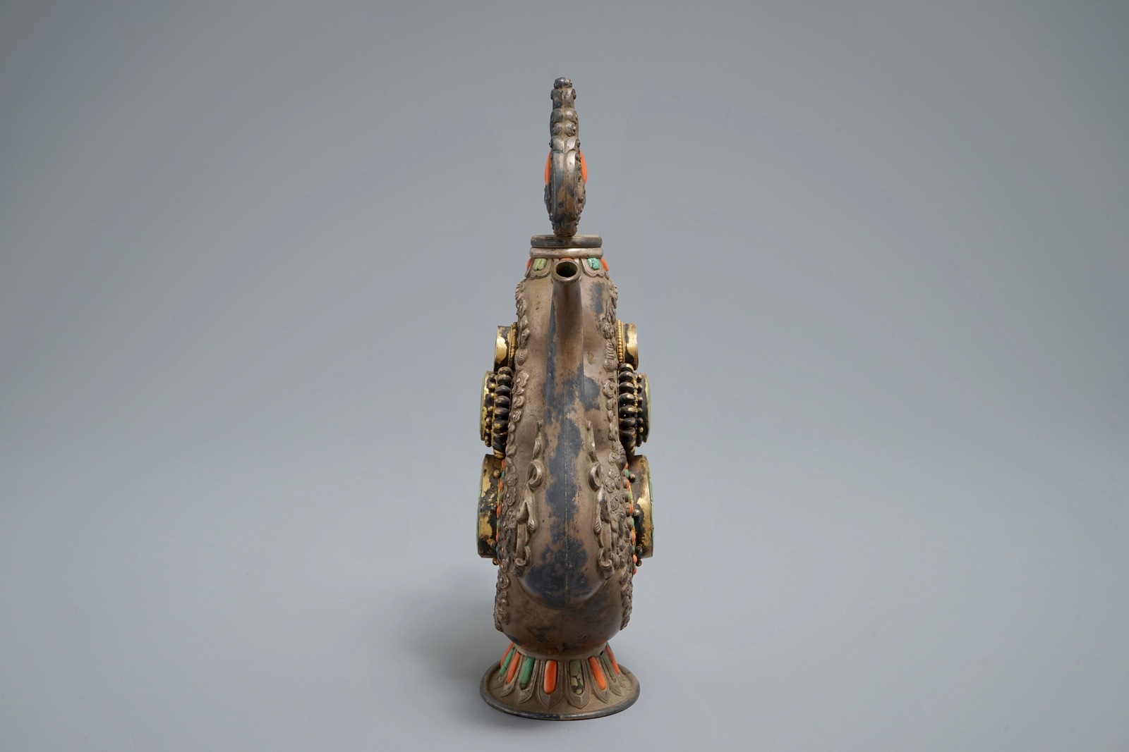 A silverd and parcel-gilt brass jug inlaid with turquoise and coral, Tibet or Mongolia, 19th C. - Image 3 of 7
