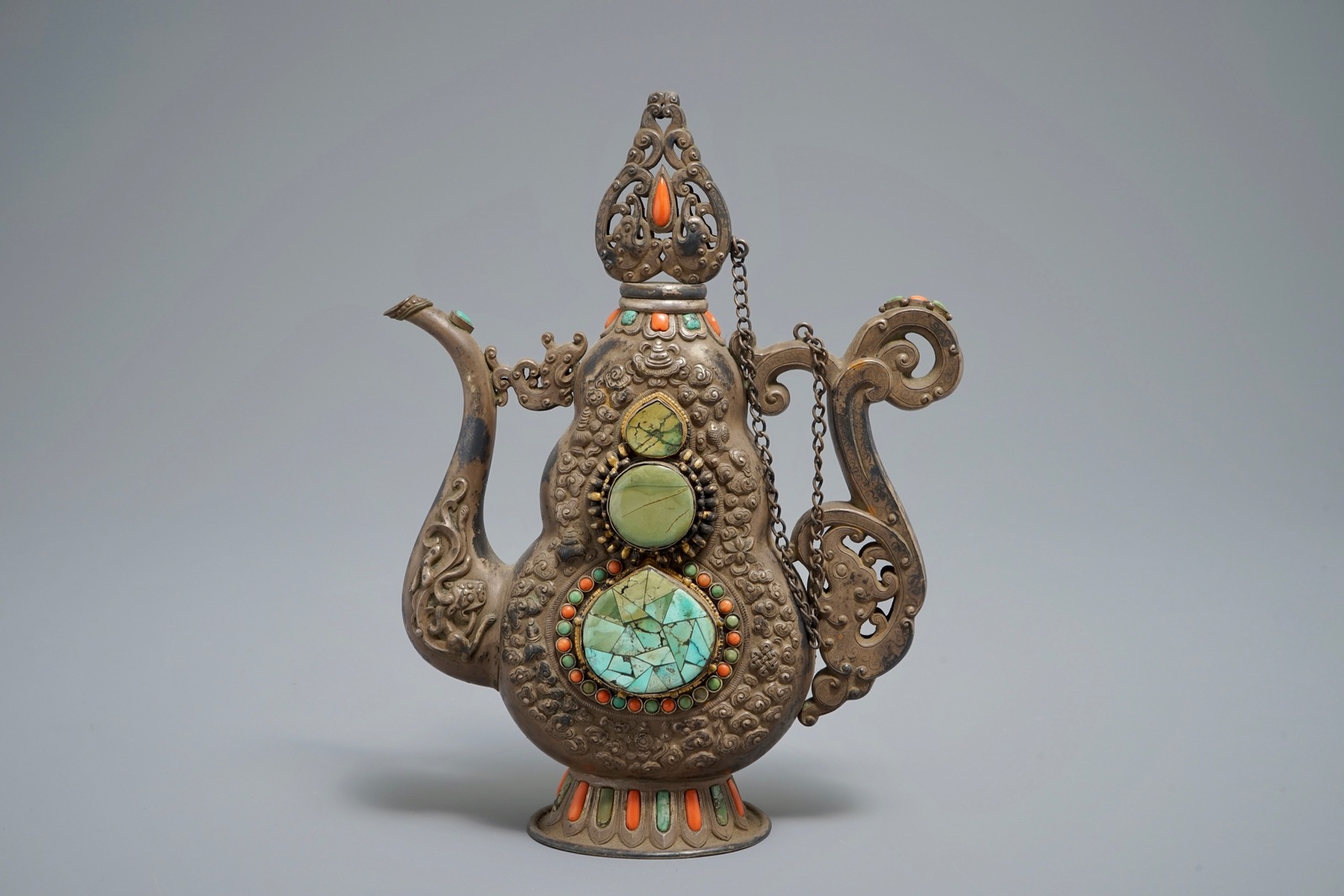 A silverd and parcel-gilt brass jug inlaid with turquoise and coral, Tibet or Mongolia, 19th C. - Image 4 of 7