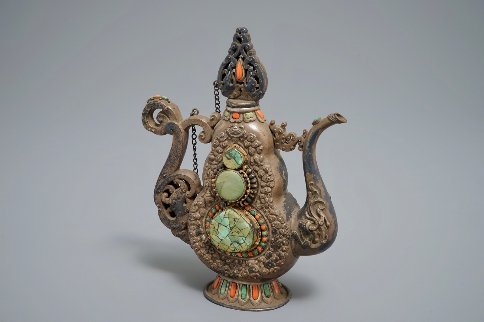 A silverd and parcel-gilt brass jug inlaid with turquoise and coral, Tibet or Mongolia, 19th C.