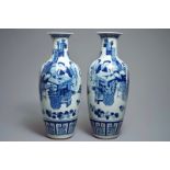 A pair of Chinese blue and white vases with ladies at a table, 19th C.