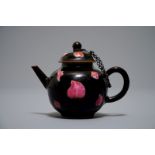 A small Chinese famille rose black-ground teapot and cover, Yongzheng/Qianlong