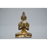 A Nepalese parcel-gilt bronze Buddha Namaskara, 16/17th C.