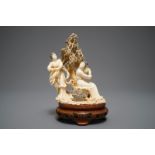 A Chinese carved ivory group of two ladies on inlaid wooden base, 1st half 20th C.