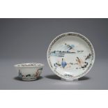 A Chinese cup and saucer with two figures in a landscape, Yongzheng