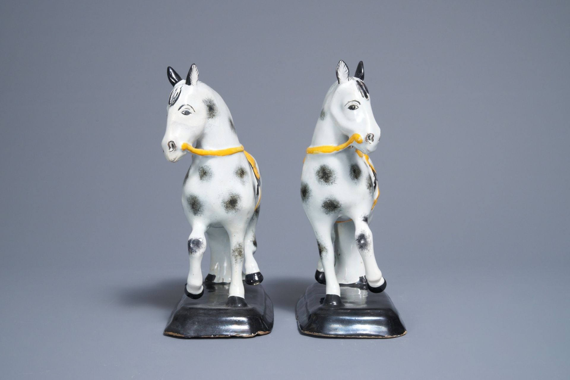 A pair of polychrome Dutch Delft black and yellow models of circus horses, 19th C. - Image 5 of 7