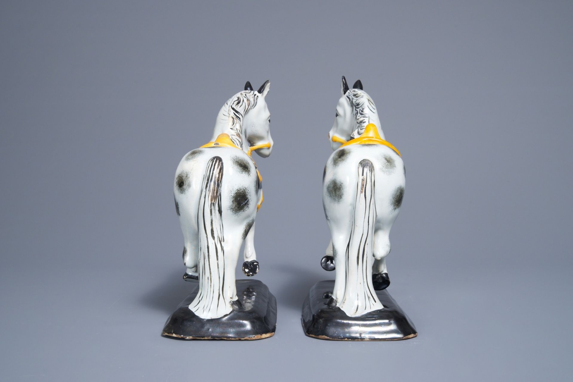 A pair of polychrome Dutch Delft black and yellow models of circus horses, 19th C. - Image 3 of 7