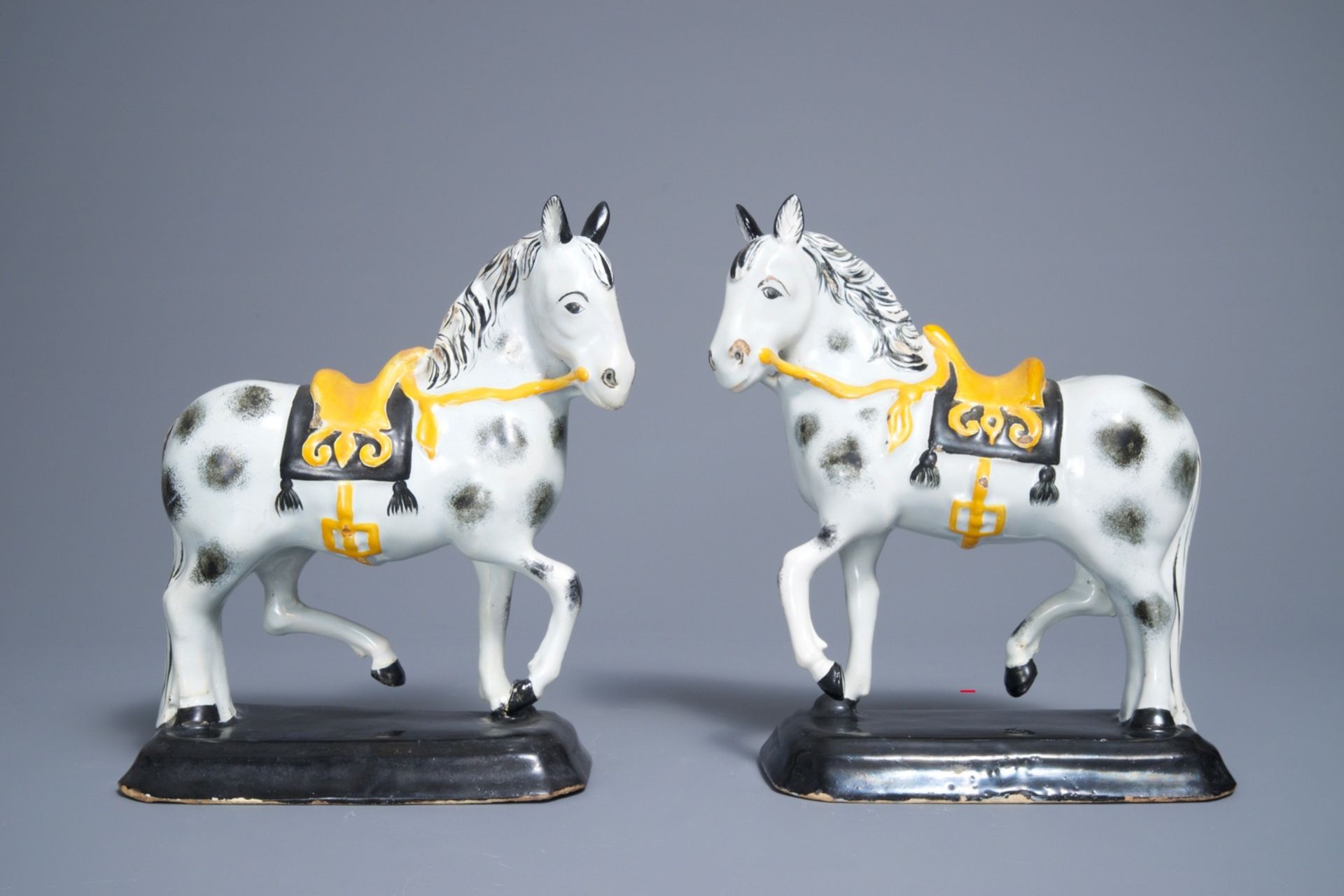 A pair of polychrome Dutch Delft black and yellow models of circus horses, 19th C. - Image 2 of 7