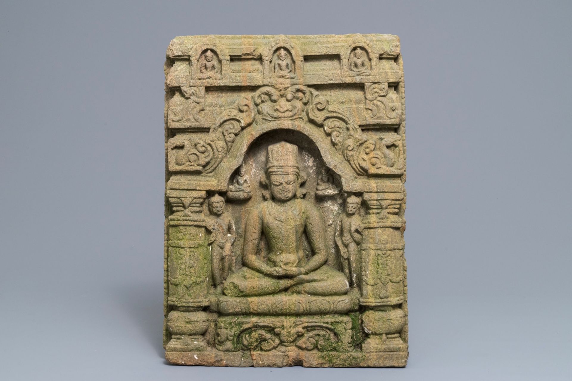 An Indian sandstone relief depicting the seated Buddha in a temple, 12/13th C.