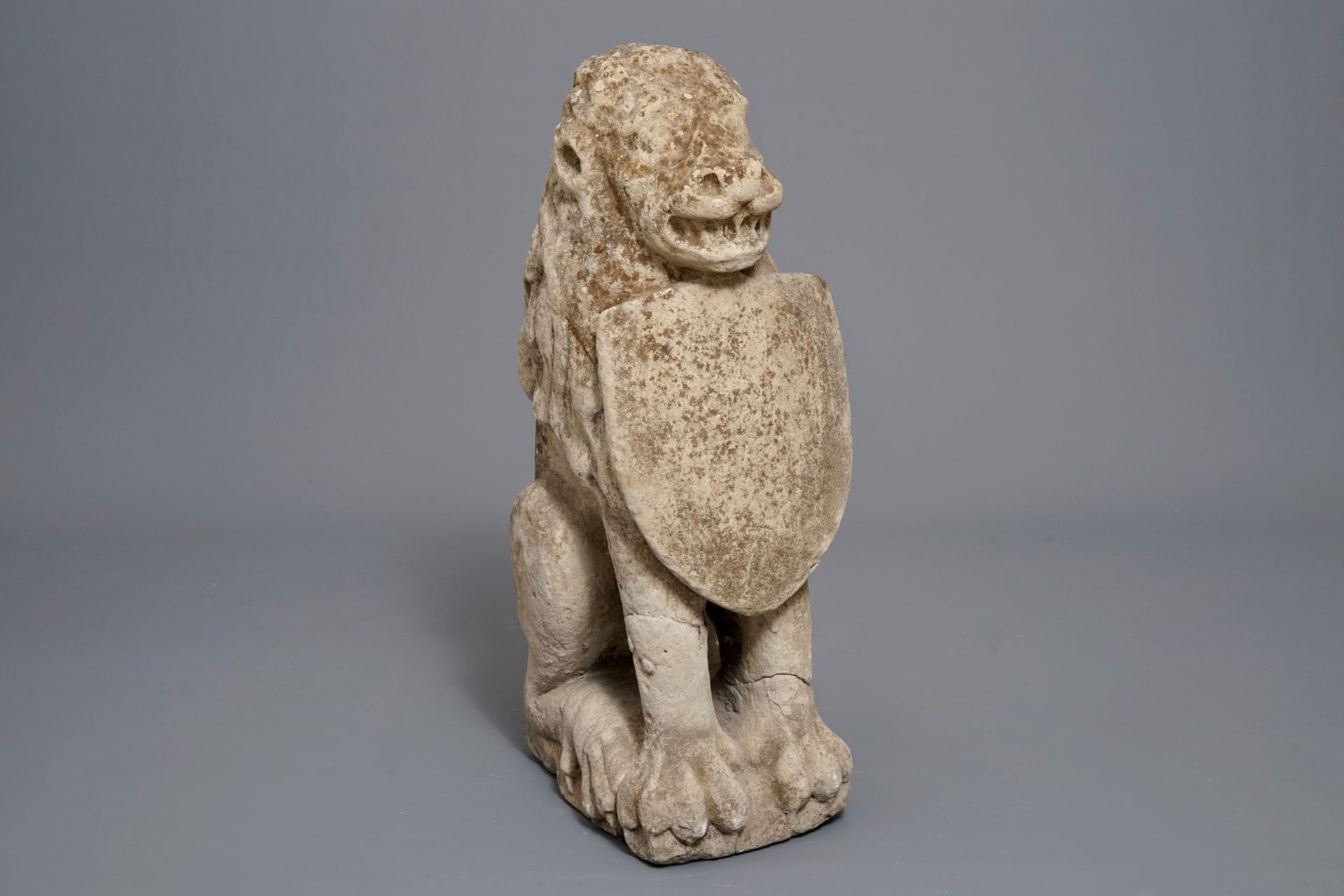 A large stone model of a lion with shield, probably Flemish, 17th C.