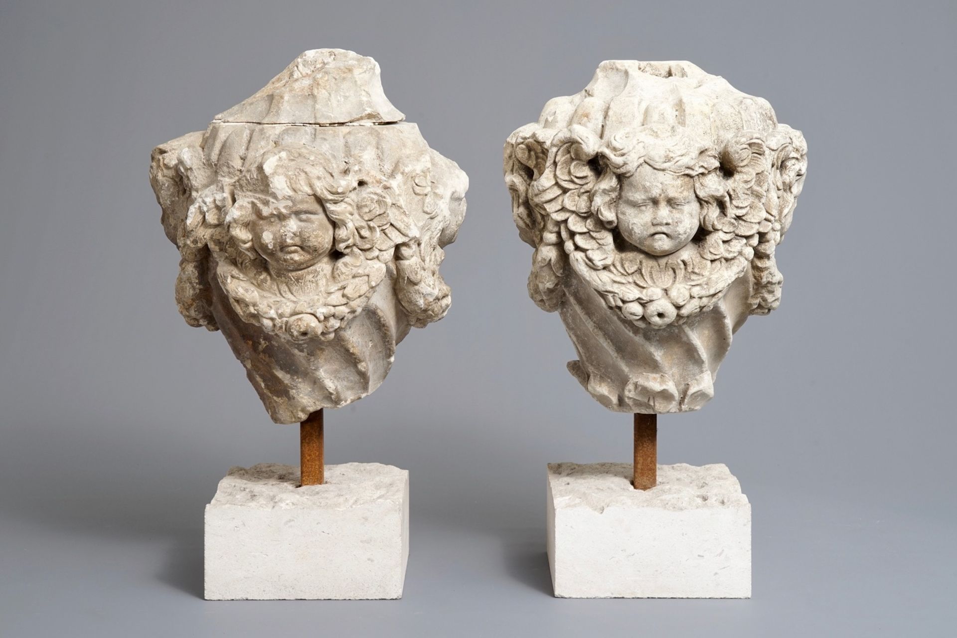 A pair of architectural stone ornaments with cherub's heads and garlands, 18th C.