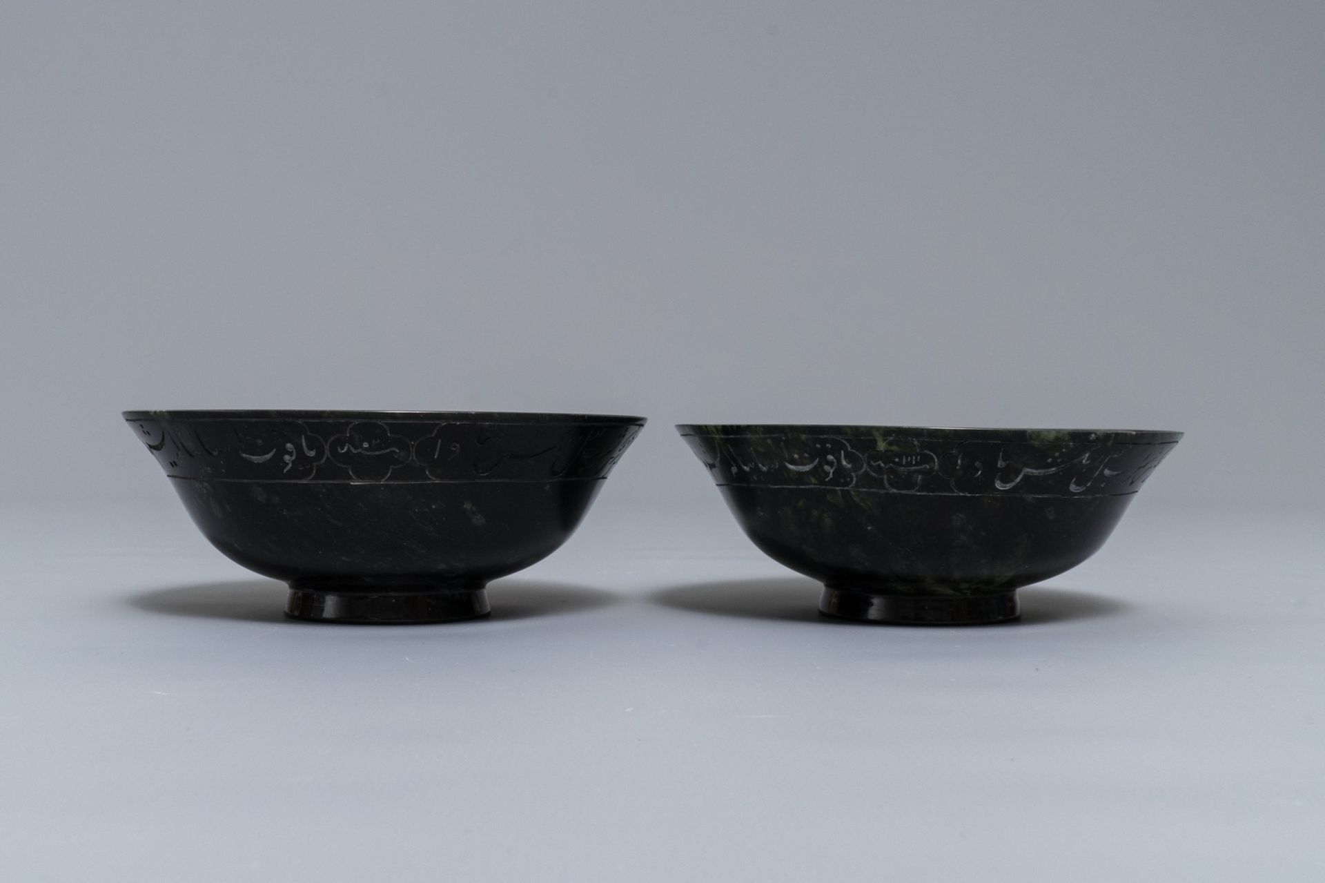 A pair of dark spinach green jade bowls with Arabic or Urdu inscriptions, India, 19/20th C. - Image 3 of 7