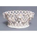 A white-glazed reticulated 'grape vines' basket, France or Italy, 19th C.