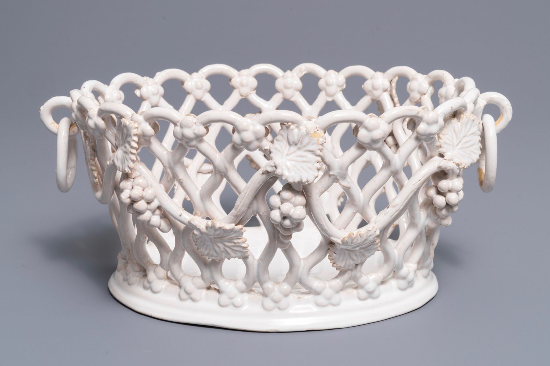 A white-glazed reticulated 'grape vines' basket, France or Italy, 19th C.