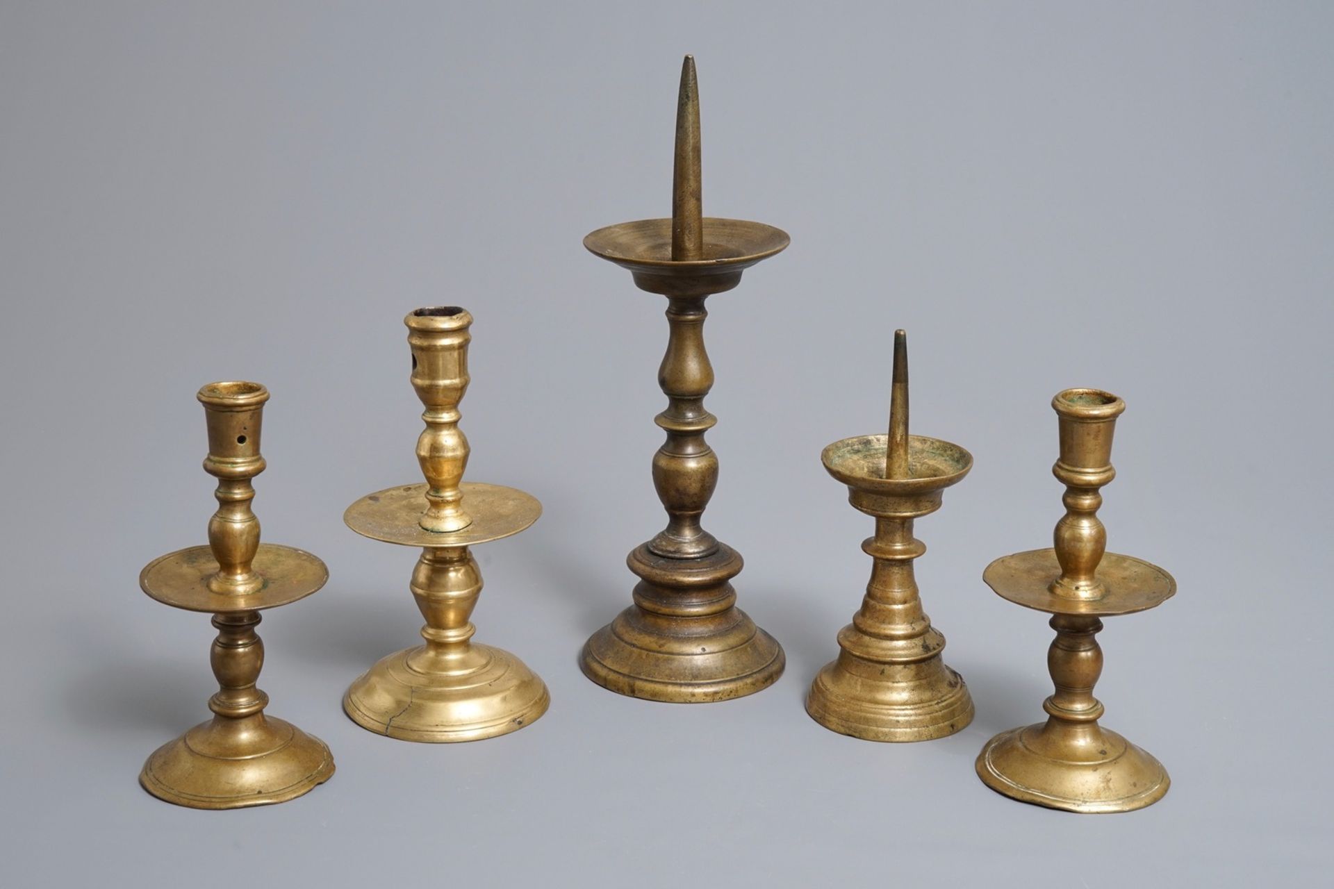 Five Flemish bronze and brass pricket and 'Heemskerk' candlesticks, 16/17th C.