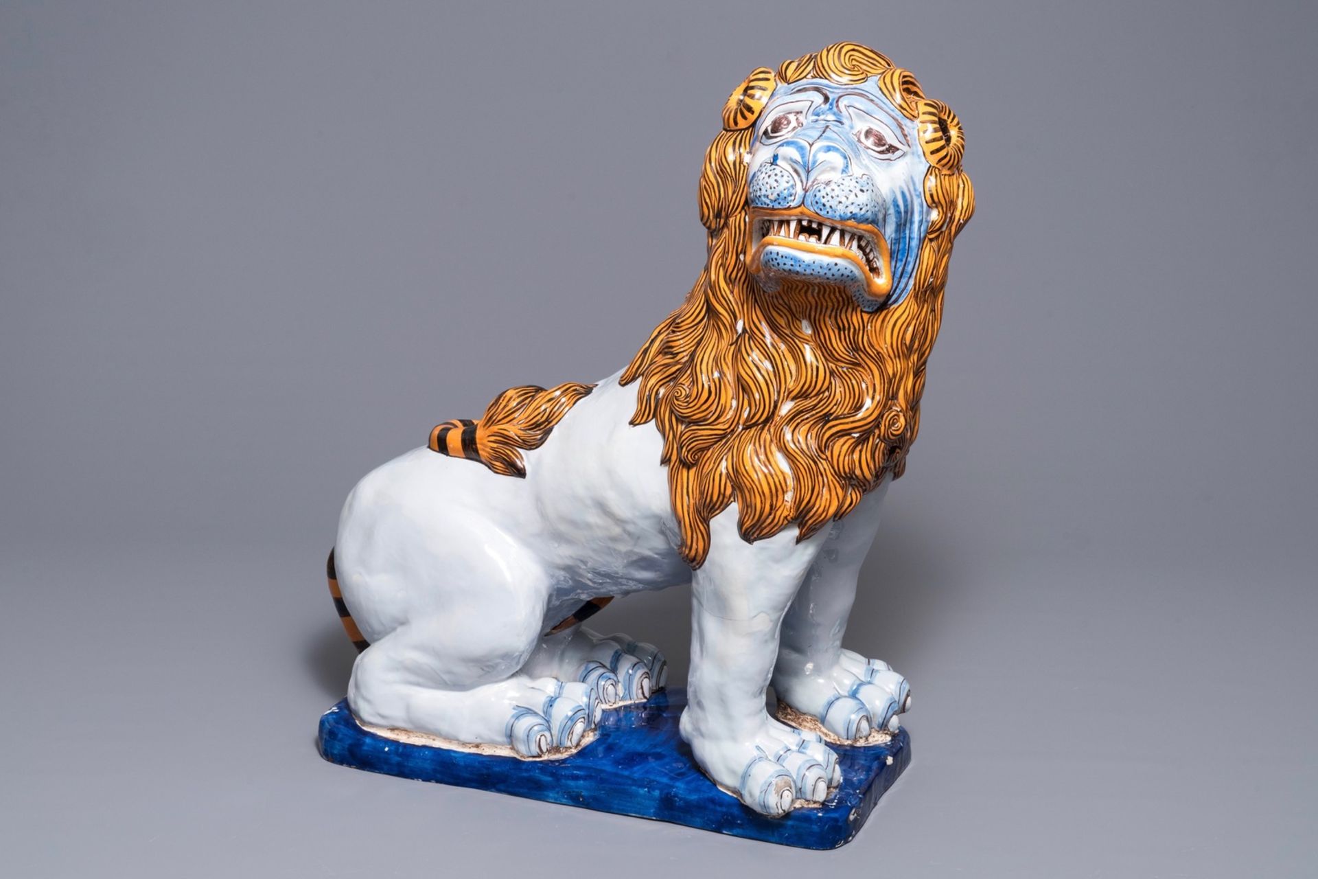 A massive French faience model of a lion, Rouen, late 19th C