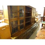 An Old Charm three-section lounge unit with cupboard & drawer bases, central bookshelf flanked by