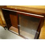 A vintage sliding two-glass door narrow dark wood bookcase