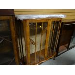 A vintage light mahogany veneer shaped top glass door display cabinet