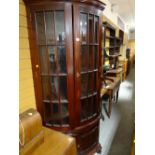 A modern dark wood floor standing corner cupboard with bevelled glazed upper & two-door cupboard