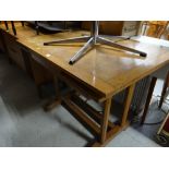 A vintage light oak pullout extending dining table