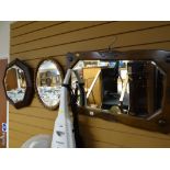 Two vintage oak framed bevelled glass wall mirrors together with a similar vintage bevelled glass