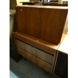 A vintage compact pull down three-drawer bureau