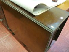 Polished gate leg table with end drawer and cupboard