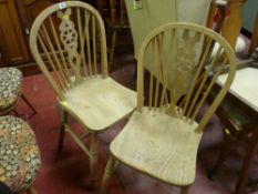 Two pine wheelback dining chairs