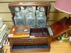 Three bottled tantalus with possibly silver presentation plaque dated 1912-1914 'Liverpool Centre'