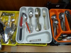 Five plastic trays with flatware contents