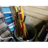 Quantity of long handled garden tools in a plastic bin, ironing board etc