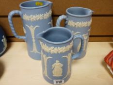 Graduated set of three blue semi-glazed Staffs jugs with classical decoration