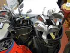 Three golf bags, two with an excellent selection of golf clubs