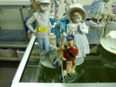 Standing Scotsman pottery flask and two Nao porcelain figurines
