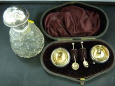 Neat little set of hallmarked silver salts and spoons and a silver topped glass scent bottle