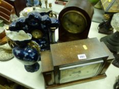 Edwardian mahogany dome topped mantel clock, polished mantel clock with oblong dial and a pottery
